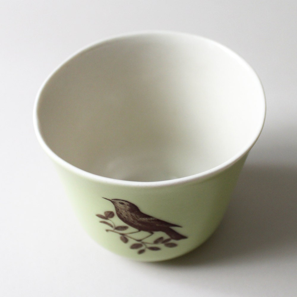 celery-green tulip cup with bird on a branch