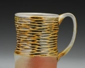 Ripple Mug with amber glaze, hand carved texture, wood and soda fired, porcelain