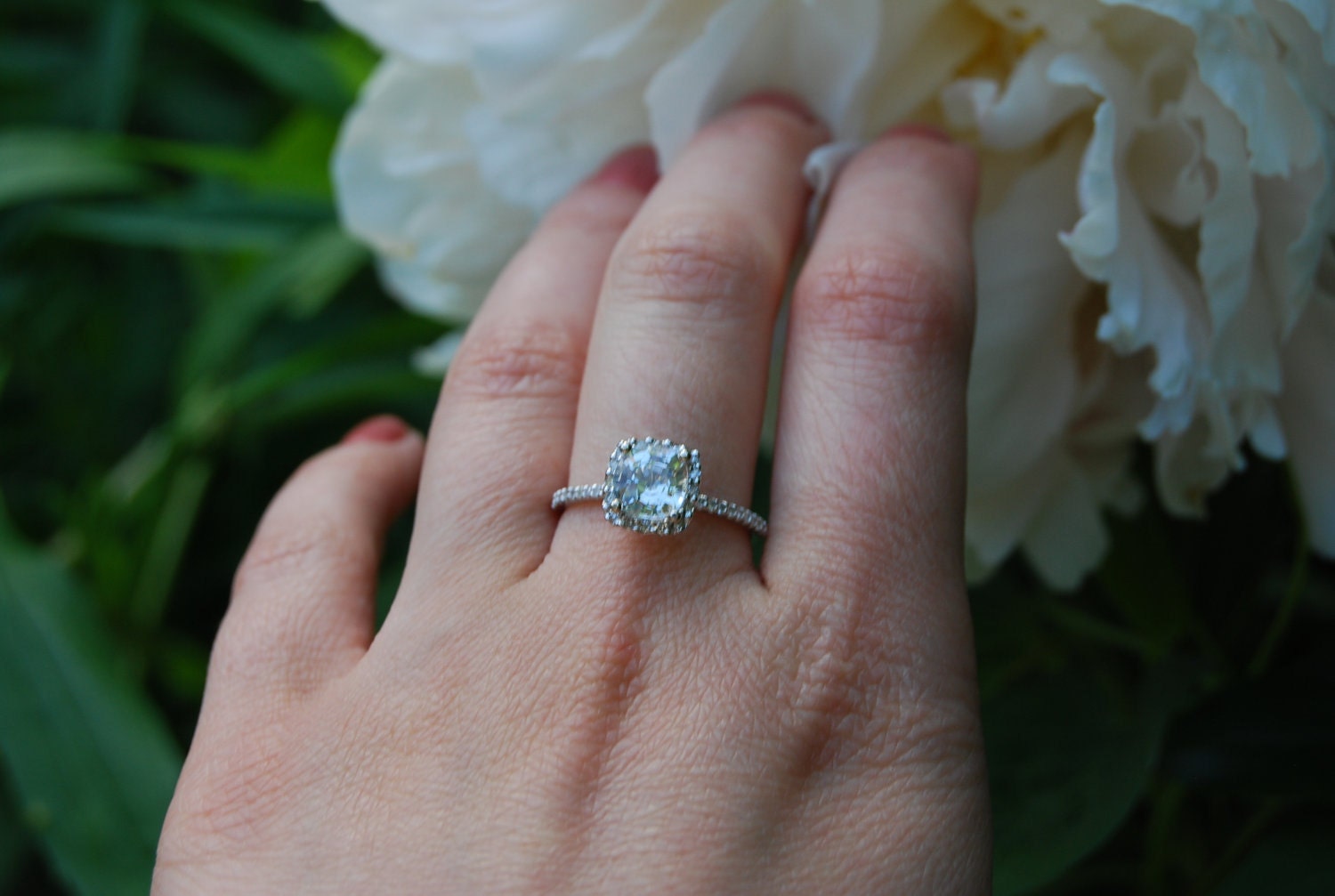 Sparkling brilliant sapphire in a 14k white gold cushion diamond setting