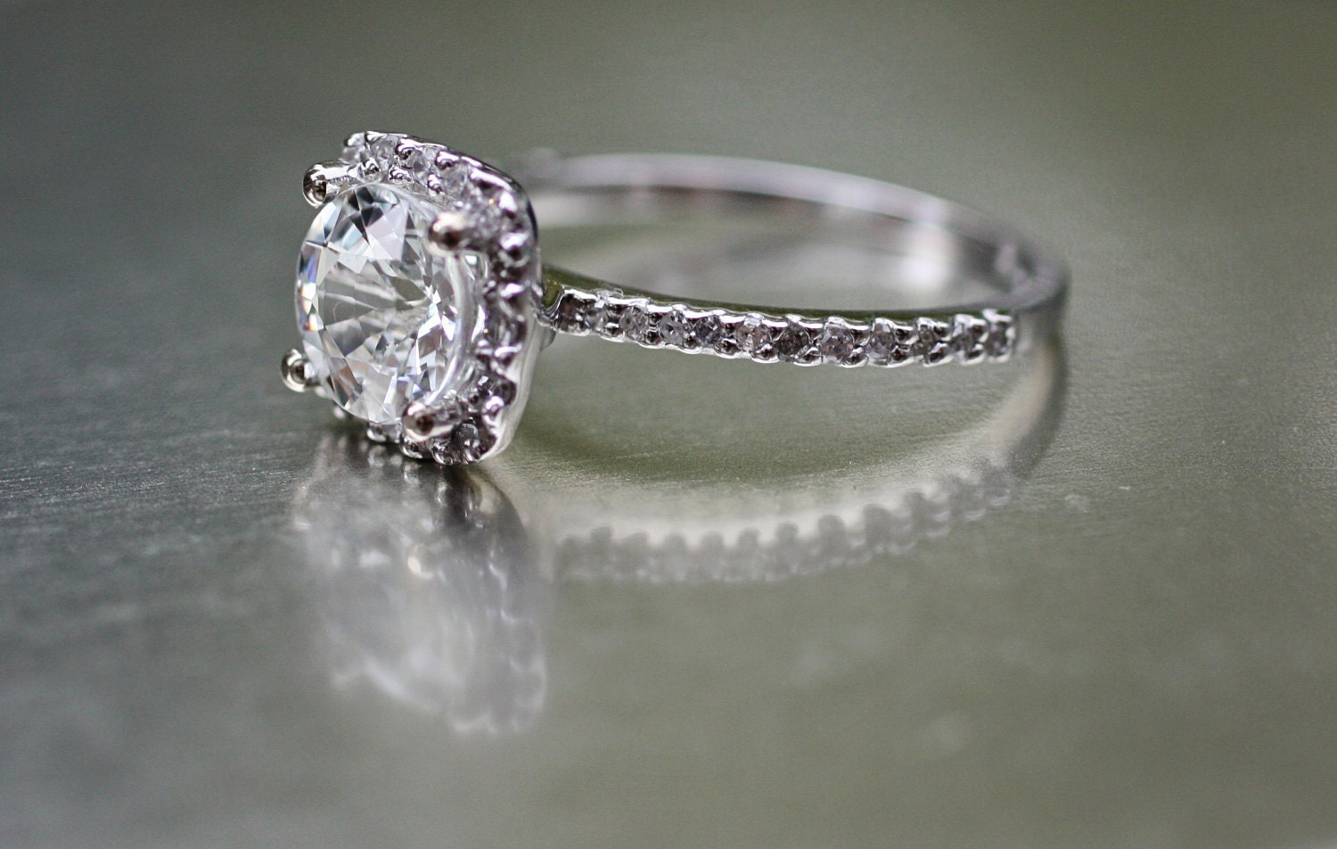 Sparkling brilliant sapphire in a 14k white gold cushion diamond setting