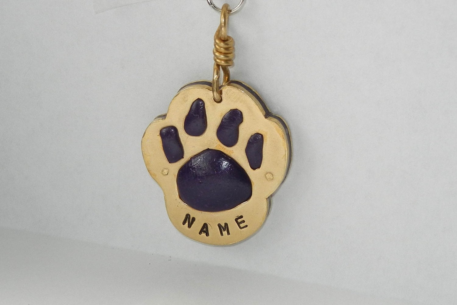 Custom stamped brass and purple paw print dog id tag