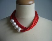 Red multistrand necklace with white pearls
