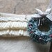 handmade ruffled wool christmas stocking with tiny bottle brush wreath