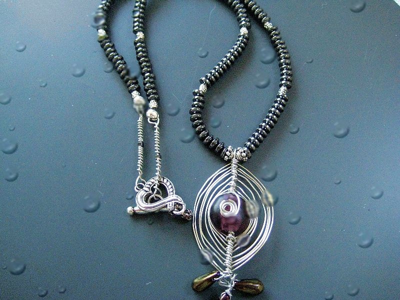 An Evil eye jewelry-  Herring Bone Wire wrapped necklace in silver and hematite- for Mothers Day