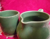 Bright green pot bellied pitcher and matching little mug
