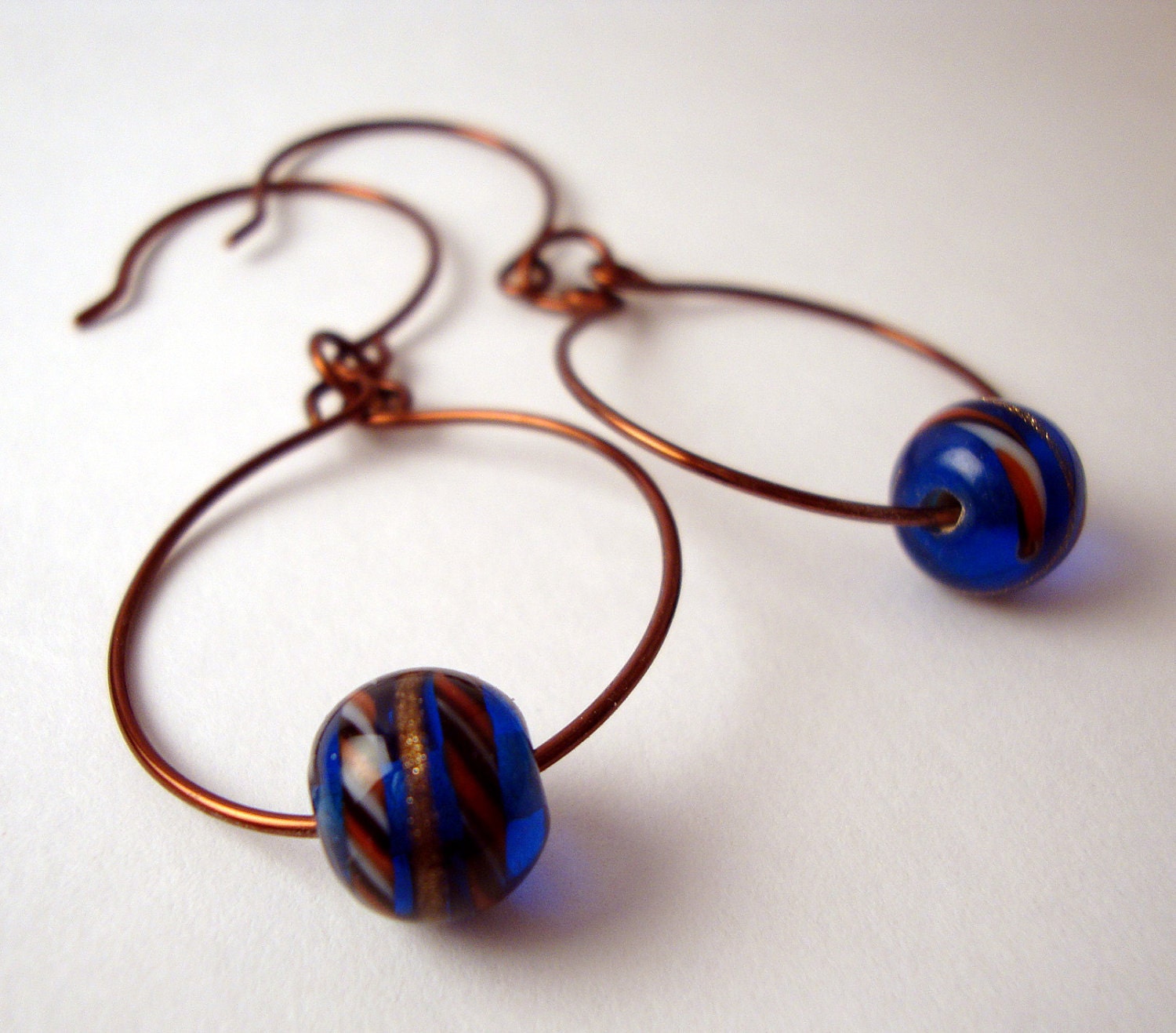Copper hoops with blue swirled art glass bead