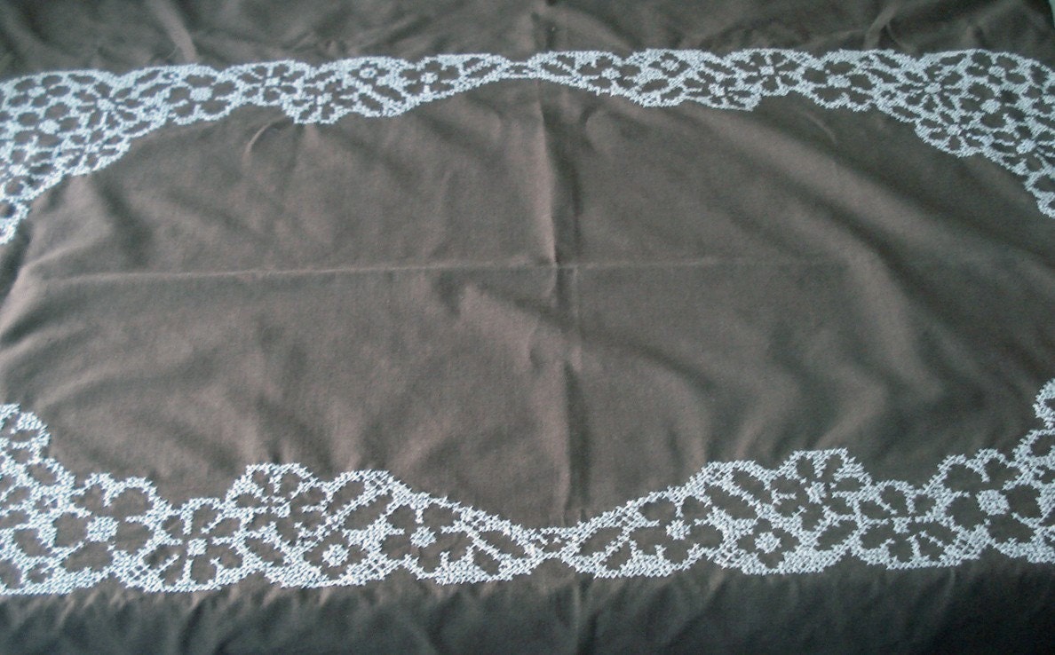 Creamy cafe au lait color tablecloth with white stitching detail and 8 matching napkins
