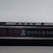 Vintage 1970s General Electric alarm clock with red digital numbers and woodgrain exterior
