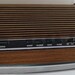 Vintage 1970s General Electric alarm clock with red digital numbers and woodgrain exterior