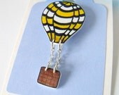 yellow and blue hot air balloon brooch with dangly basket