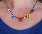 Colorful Flower Chain beaded crocheted necklace in red, green, yellow, and blue