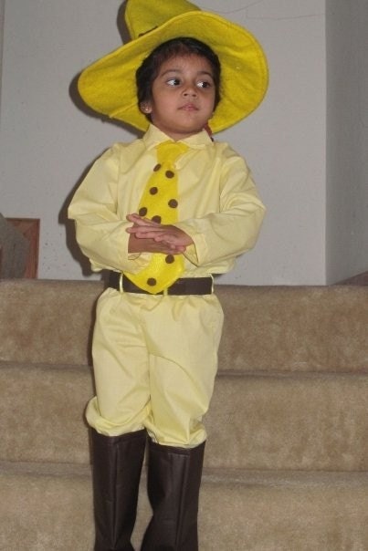 man in yellow hat costume curious george