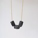 geometric necklace with faceted black wooden beads on a puristic fine ballchain