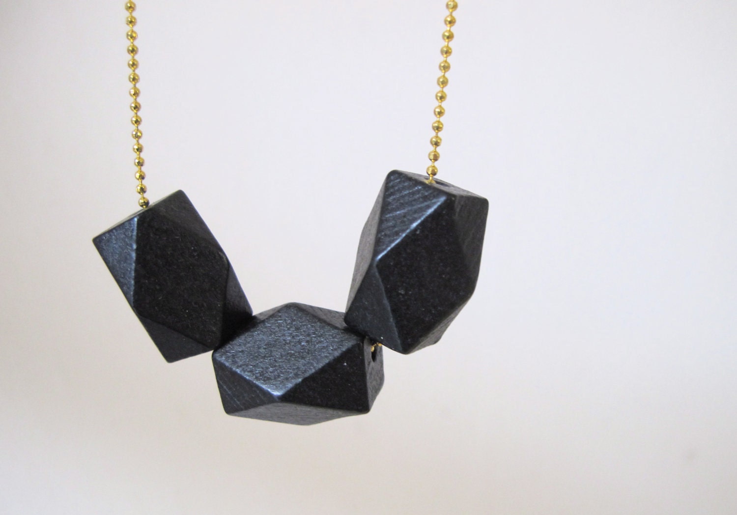 geometric necklace with faceted black wooden beads on a puristic fine ballchain