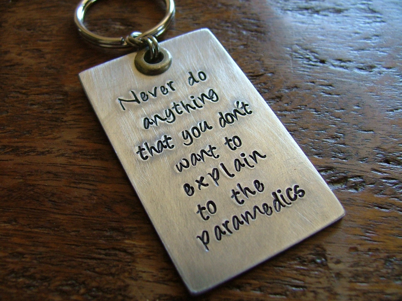 Never do anything that you don't want to explain to the paramedics. - Custom hand stamped keychain by MyBella