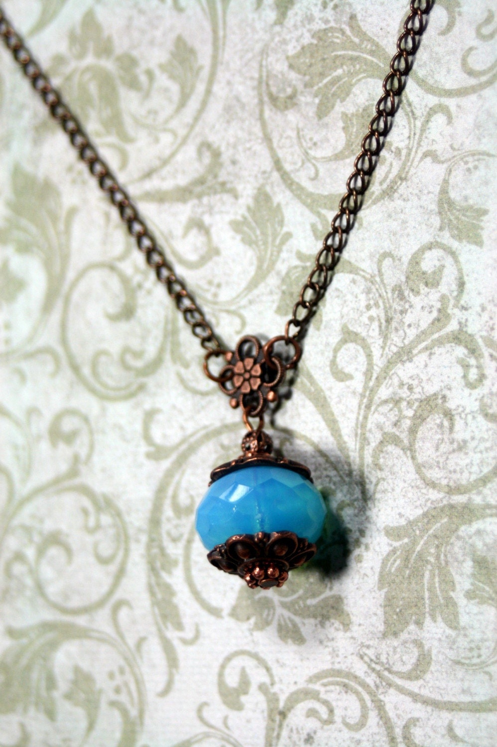 Holding Summer Antique Copper Necklace with Vintage Glass Bead