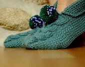 Knitted slippers light sage green with big pom poms.
