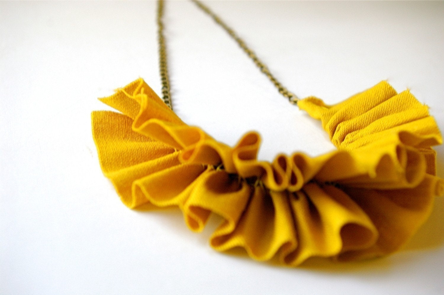 linen ruffle necklace in mustard yellow. antique bronze chain.