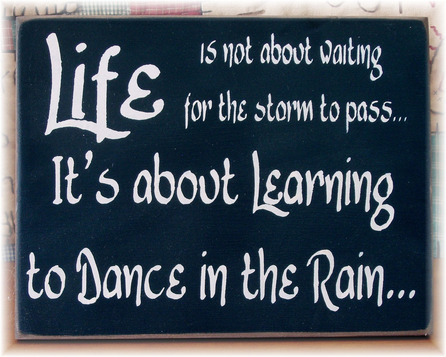Life is not about waiting for the storm to pass it's about learning to dance in the rain sign