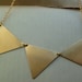 Bunting necklace, triple brass triangles