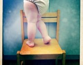 Baby love - cutie baby legs standing on a chair