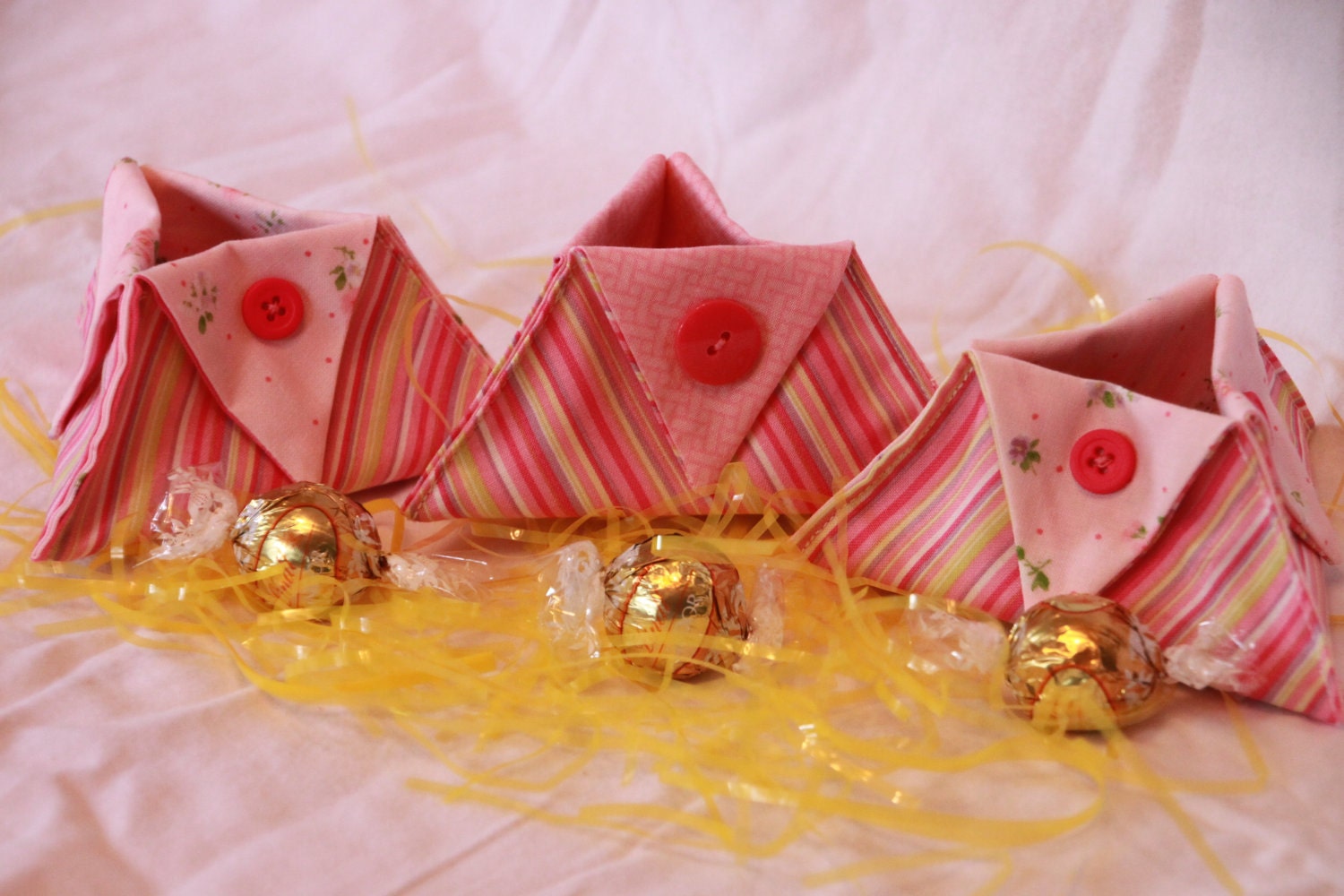 Set of three small pink fabric baskets