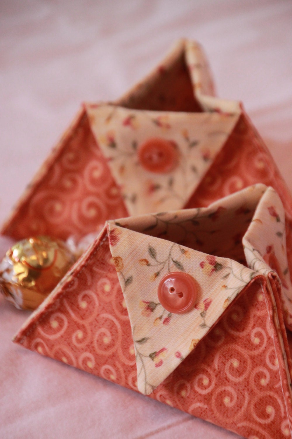 Set of four small dark pink fabric baskets