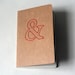 stitched moleskine notebook, red ampersand (lined pages)