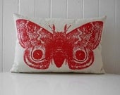 Giant Io Moth silk screened cotton canvas throw pillow 12x18 inch red on sandstone