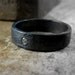 Darkened sterling silver men's ring band with flush set diamond, blackened sterling silver