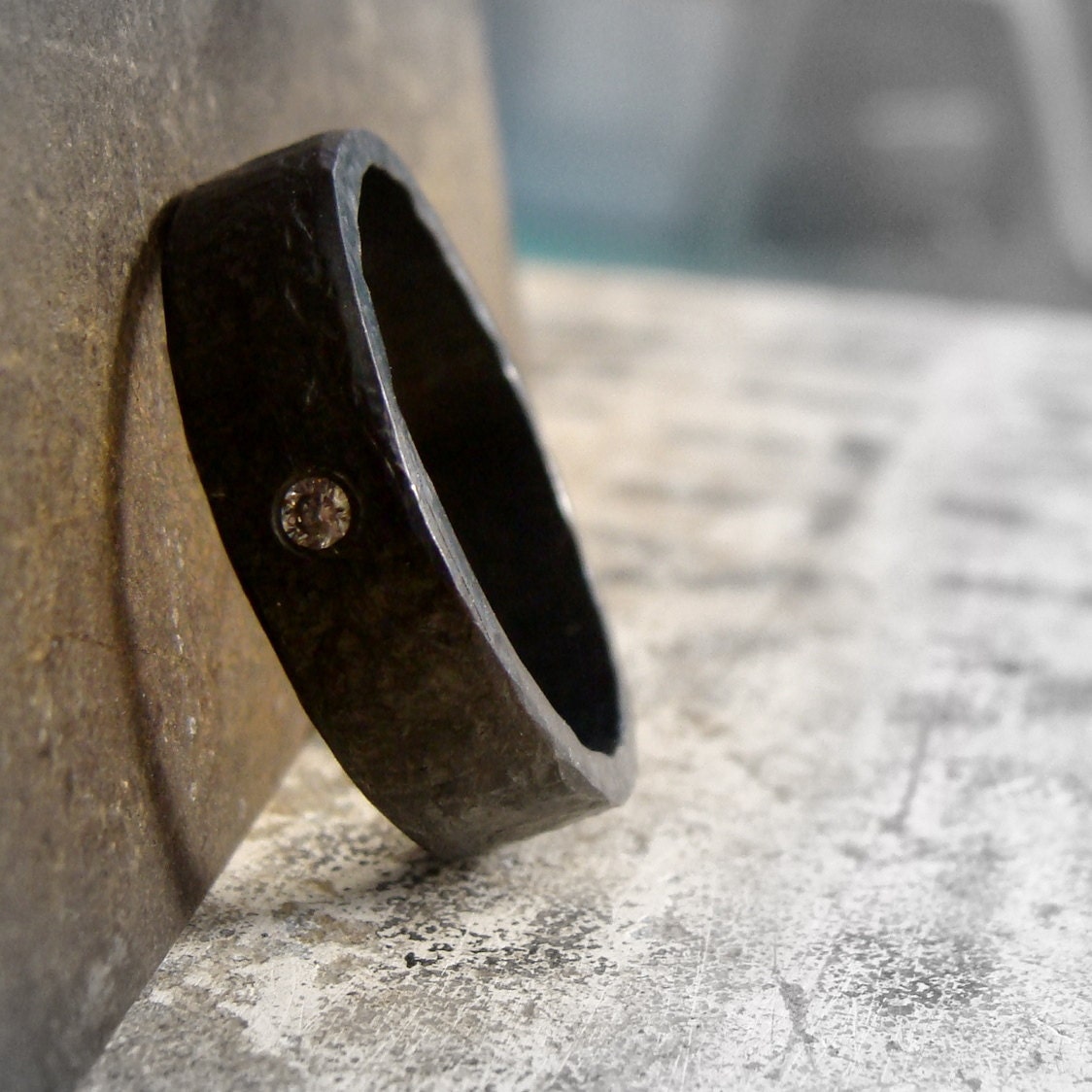 Darkened sterling silver men's ring band with flush set diamond, blackened sterling silver