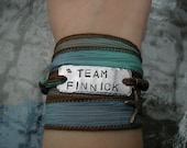 The Hunger Games Bracelet Wrap - TEAM FINNICK Hand Stamped  with Sea Foam Green/ Blue Silk Ribbon Wrap
