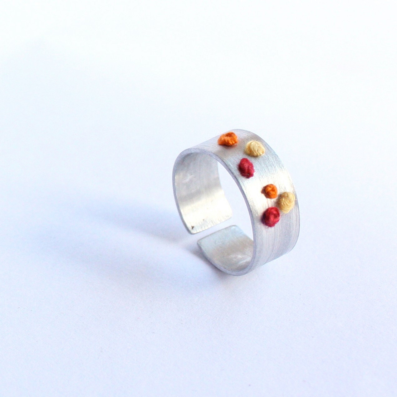 Aluminium ring with cotton embroidery - red, yellow and orange