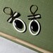 Oval black and white enameled earrings