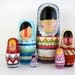 handmade wood folk art nesting dolls... wool sweater Eskimos