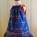 Organic cotton pillowcase dress with cute dancing giraffes and ruffled hem and orange ribbon trim