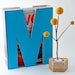 M is for magazine. in turquoise.