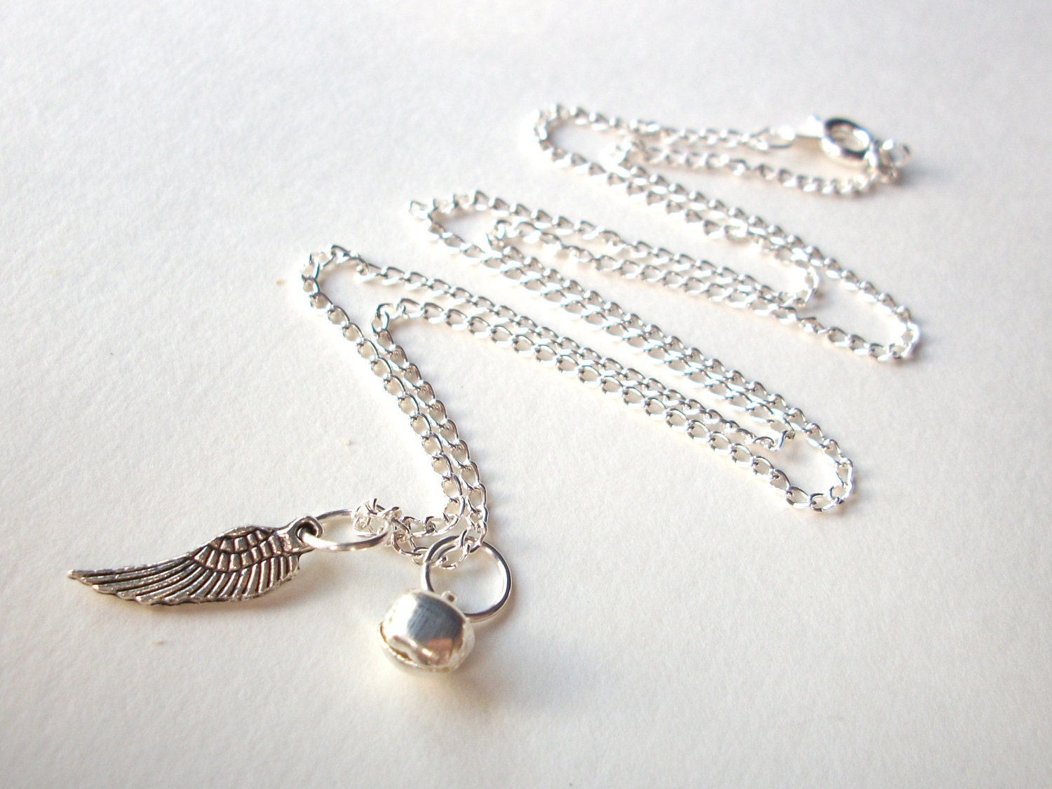 Miscarriage necklace, silver angel wing and tinkling bell charms on silverplated chain infant loss remembrance