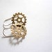 Steampunk gold earrings. Delicate brass clock gears on sterling silver.