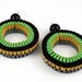 The Coco woven hoop earrings in spring green / black
