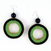 The Coco woven hoop earrings in spring green / black