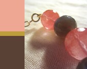 Warm smokey grey and rose semiprecious stone arc necklace. Medium length gold plated chain. Semitransparent faceted stones