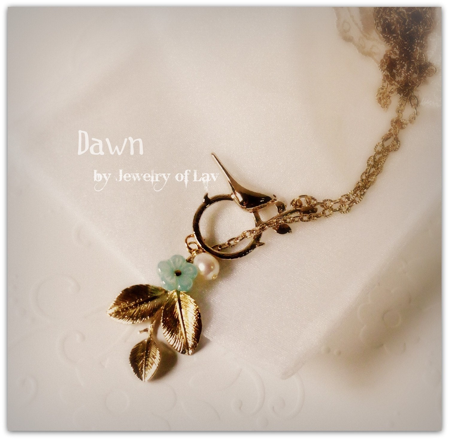 Dawn necklace made with pretty gold-plated bird charm, leaves charm, freshwater pearl, glass flower etc.