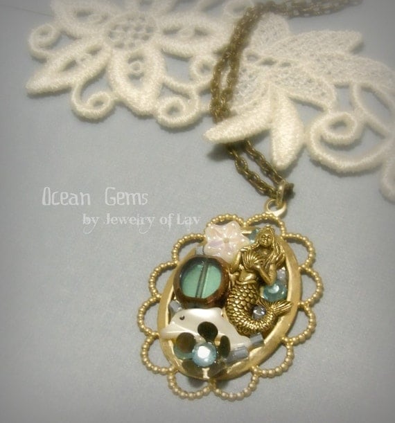 Ocean Gems made with mermaid charm, shell dolphin, flower charm, glass beads, etc.