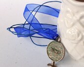 Bump Vintage Game Piece Pendant on a matching ribbon necklace