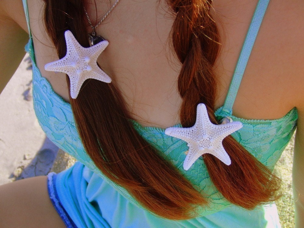 Two small white knobby starfish barrettes.