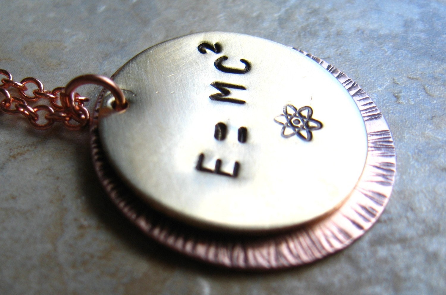 E equals MC squared - Einsteins Famous Physics Equation in a Copper Necklace