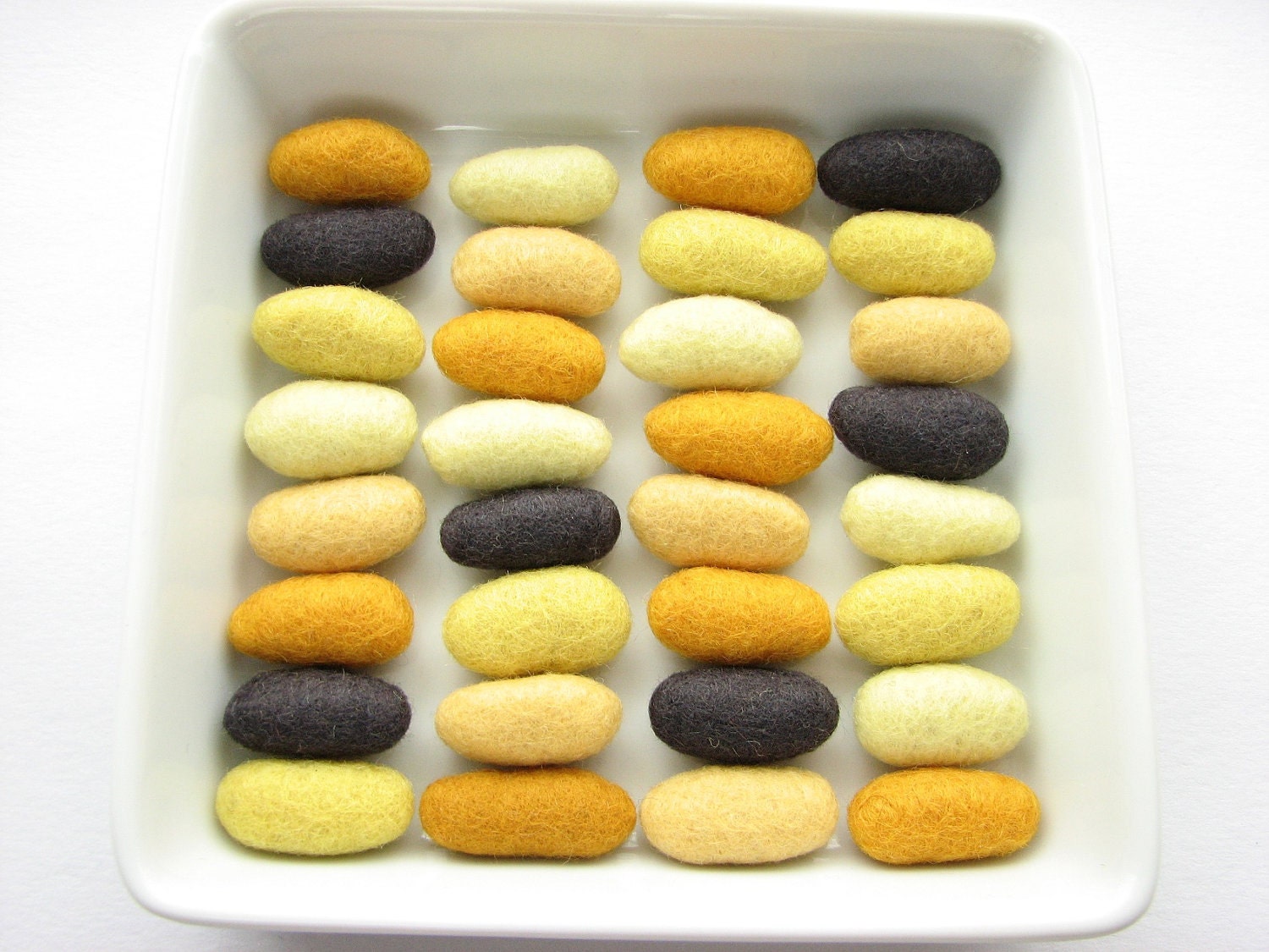 32 felted wool pebbles (dark gray and yellow shades)