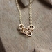gold rings necklace- the quintet