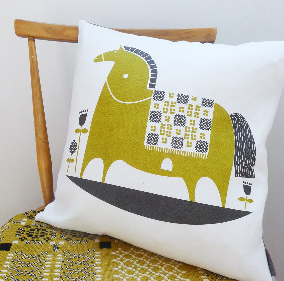 rocking horse cushion in olive on white linen